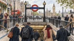 Illustration of commuters and visitors entering a London Underground station near Westminster