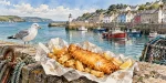 Illustration of golden fish and chips overlooking a British fishing harbour