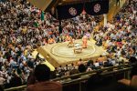 Sumo wrestlers facing each other in the ring at Ryogoku Kokugikan