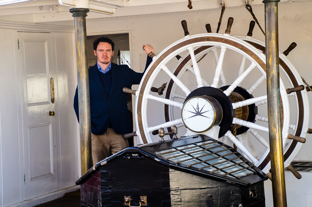 husband holding the wheel of the hms garnet at the historic dockyard chatham