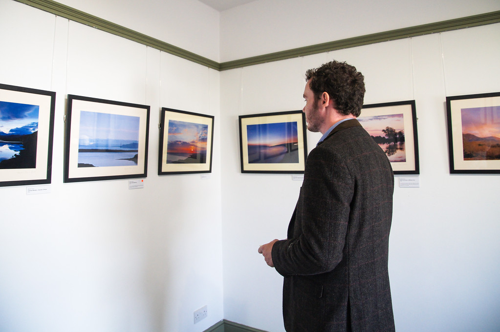husband looking at photo gallery at dimbola museum on the isle of wight Gary viewing photographs at Dimbola Museum and Galleries