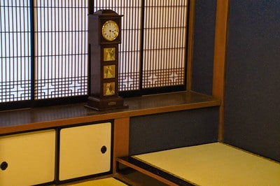 Tatami room with a tall clock at Yamamoto-tei