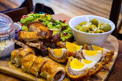 salisbury old ale and coffee house sharing platter with scotch eggs and sausage roll