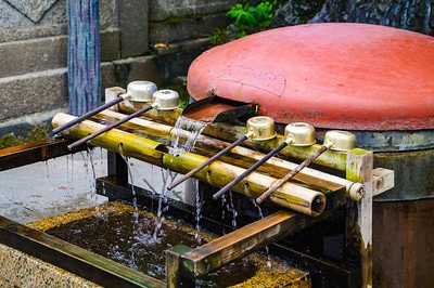 Water basin with bamboo supports and ladles at Shibamata Taishakuten