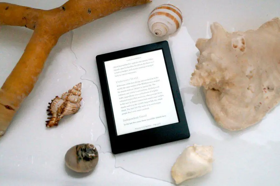 Kobo H2O Electronic reader surrounded by shells