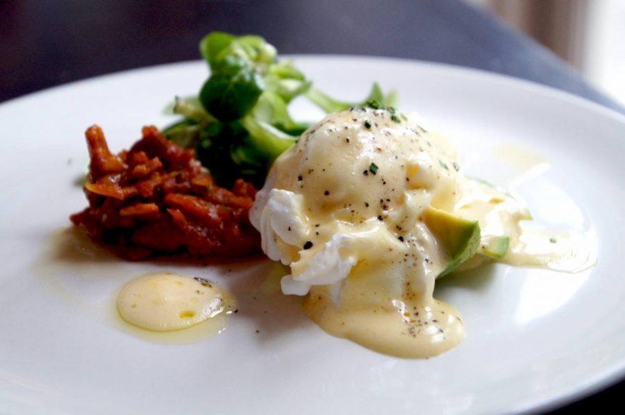 Poached Duck Egg served with Avocado Bacon Chutney and Hollandaise for breakfast at the bel and dragon in odiham