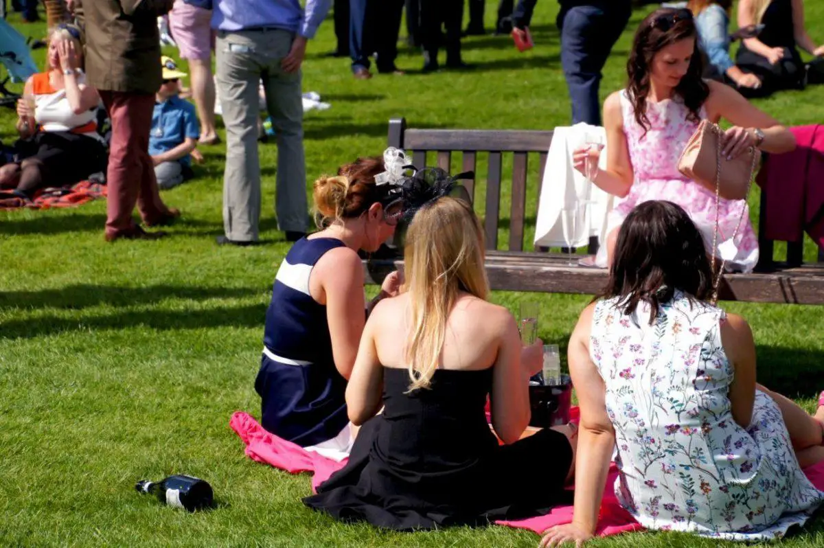 Women in fancy outfits at the Newbury Racecourse main field on al shaquab lockinge day