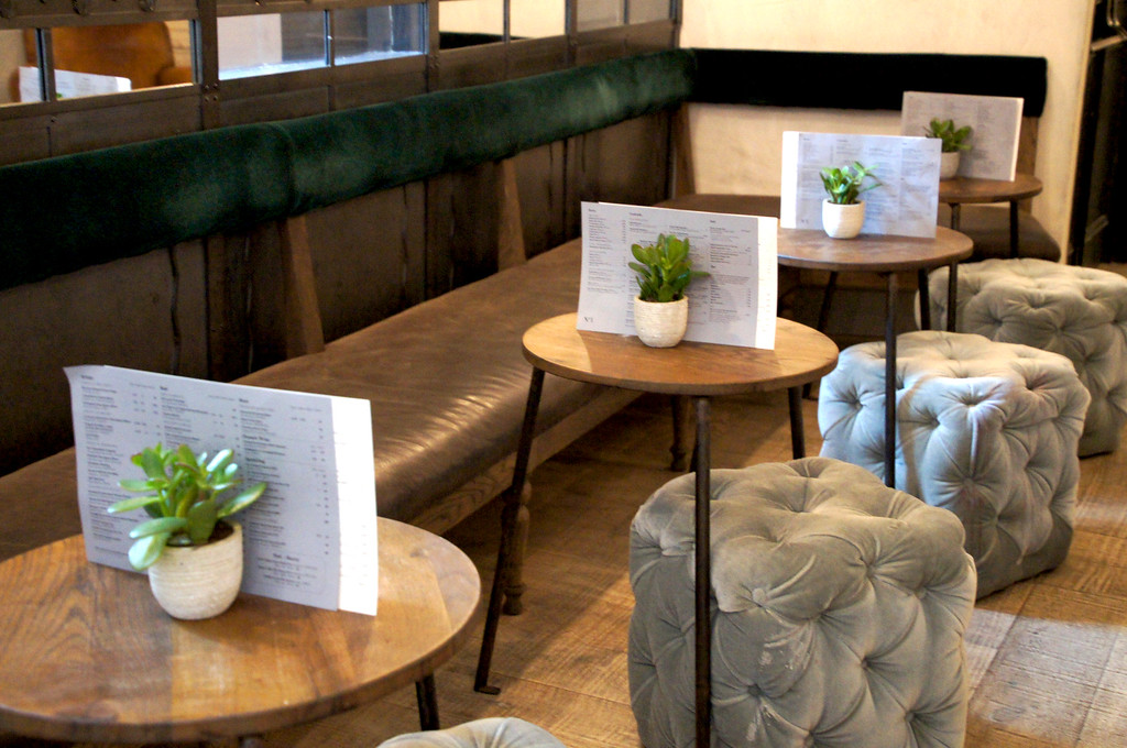 bench and stools around table in no1 duke street richmond london