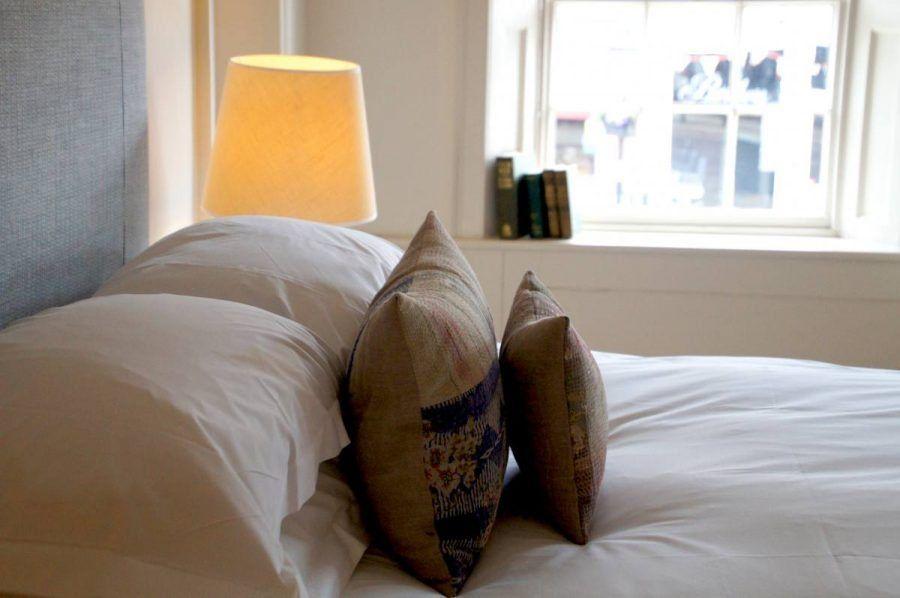 cushions on the bed in the premium double en suite room the Damson at the bel and dragon in odiham