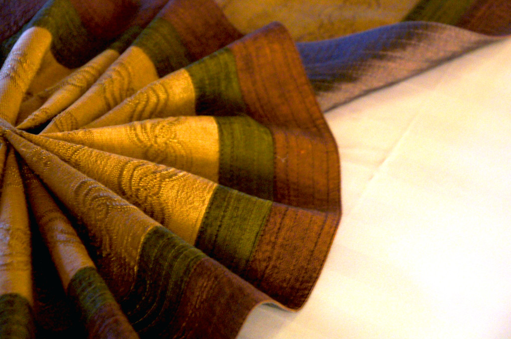 folded fabric on bed in bedroom in private villa at panviman chiang mai in thailand Folded fabric on bed in bedroom in a private villa at Panviman Chiang Mai Spa Resort