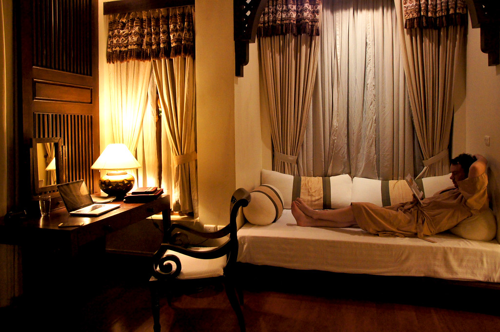 husband on lounge chair in bedroom in private villa at panviman chiang mai in thailand Husband on lounge chair in bedroom in a private villa at Panviman Chiang Mai Spa Resort