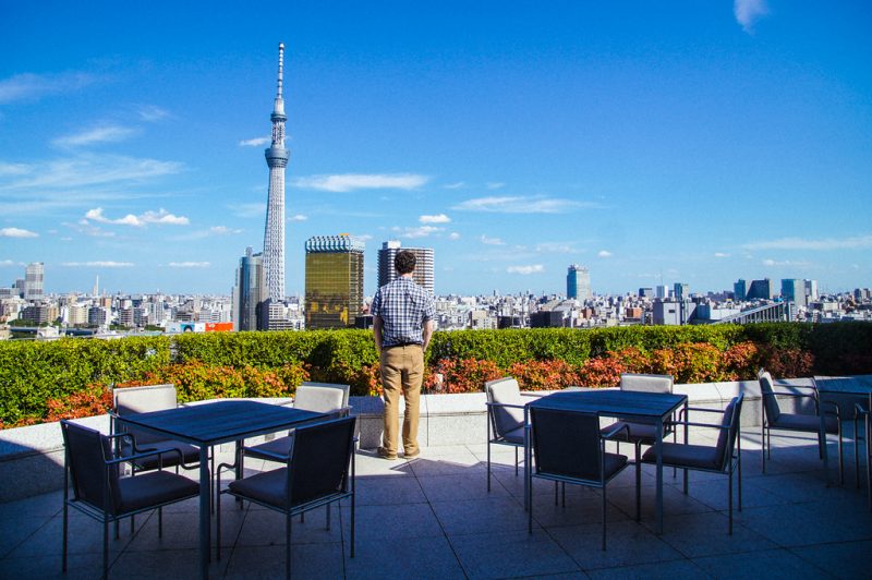 husband standing on terrace of Gate hotel kaminarimon Tokyo Skytree viewed from The Gate Hotel Kaminarimon terrace