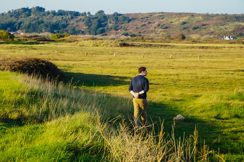 Gary walking through a field near the Jersey Wetland Centre