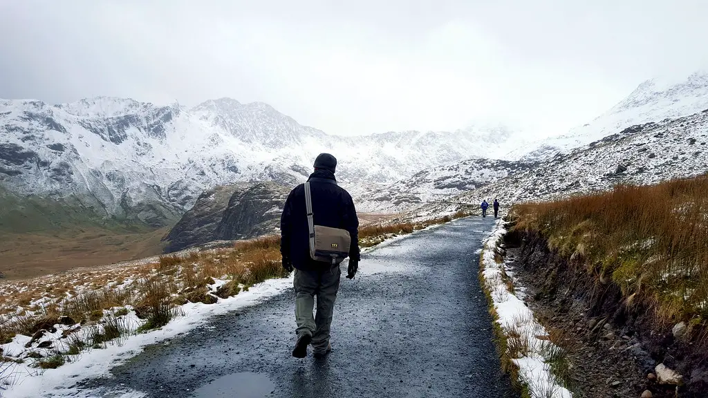 husband walking up the tarmac path of miners track up mount snowdon