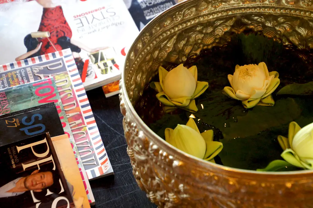 magazines and flowers in bassinet in communal lounge at 137 pillars house in chiang mai thailand