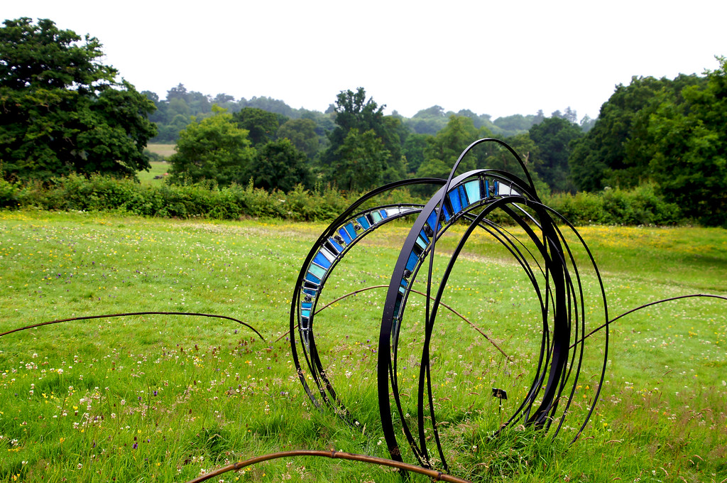 modern spiral metal and glass sculpture in borde hill gardens Modern spiral metal and glass sculpture in Borde Hill Garden