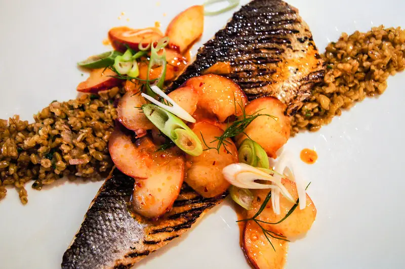 sea bass with freekeh rice a type of wheat grain and citrus peach and rose harissa at bar boulud in london picture 1