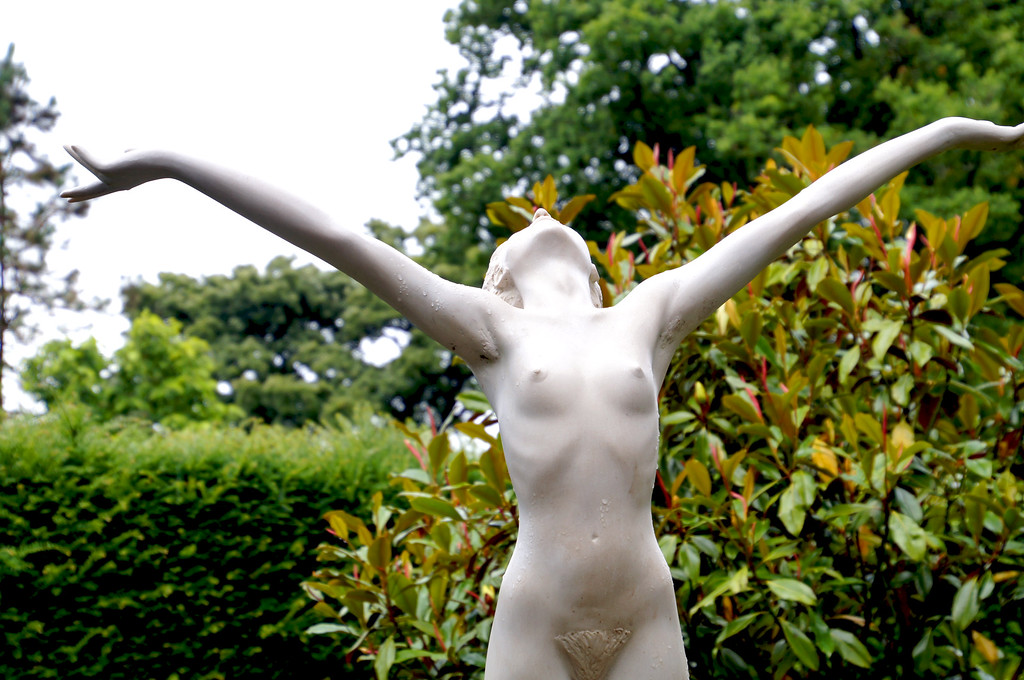 stone statue in italian garden of borde hill gardens Stone statue in italian garden of Borde Hill Garden