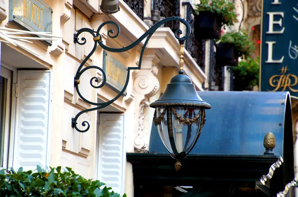 street lamp hanging from building in paris france location of hotel la tremoille