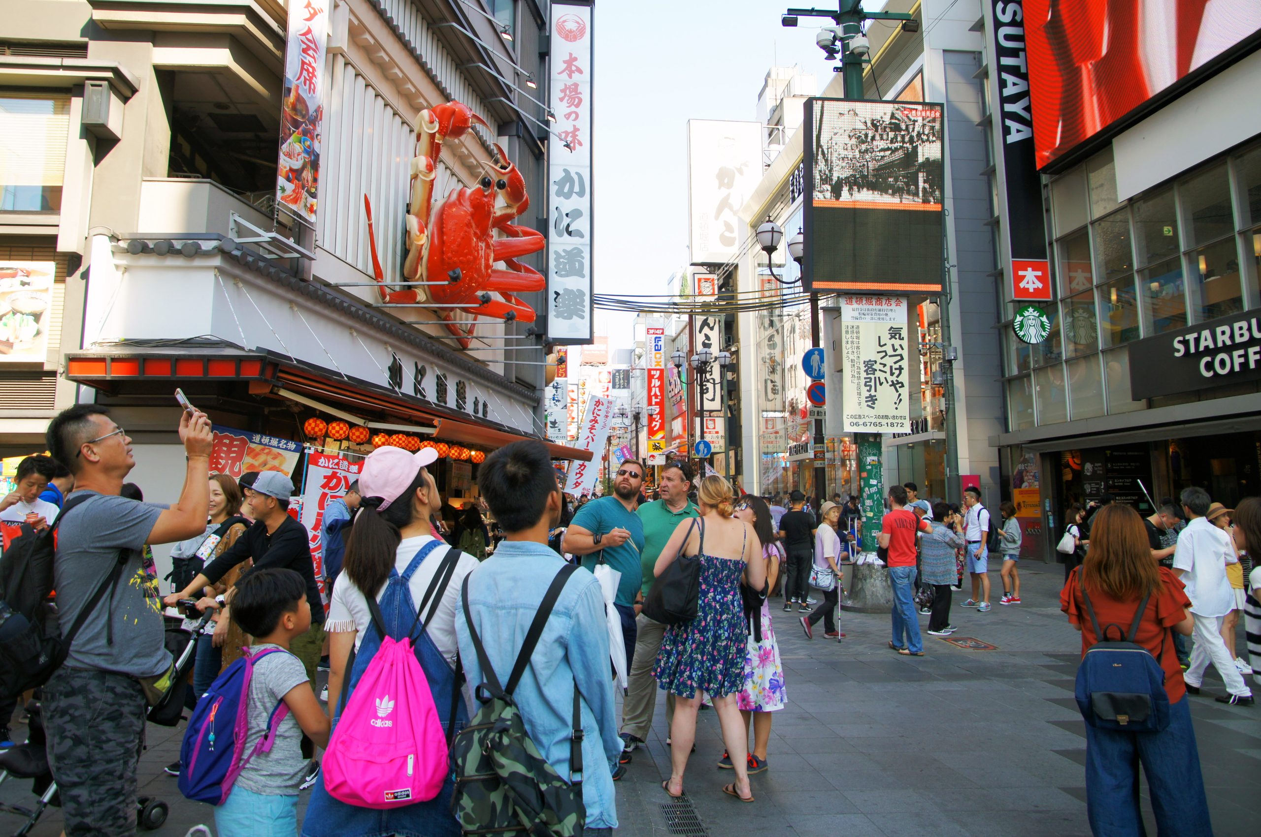 2 Week Japan Itinerary osaka dotonbori street scaled Crowds walking beneath the giant crab sign in Dotonbori, Osaka