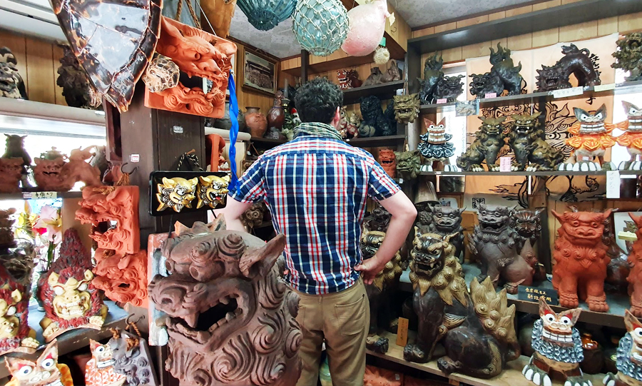 Best things to do in Okinawa Tsuboya Yachimun 2 Gary browsing shisa guardian figures in a Tsuboya pottery shop
