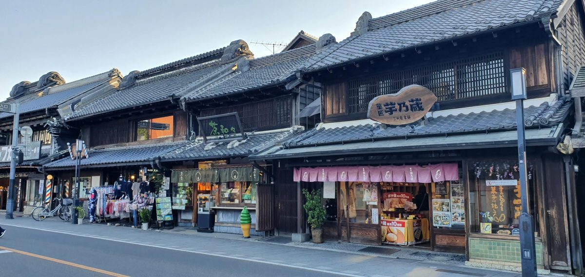 Visitors walk past traditional shopfronts along Kawagoe's Kurazukuri Street.