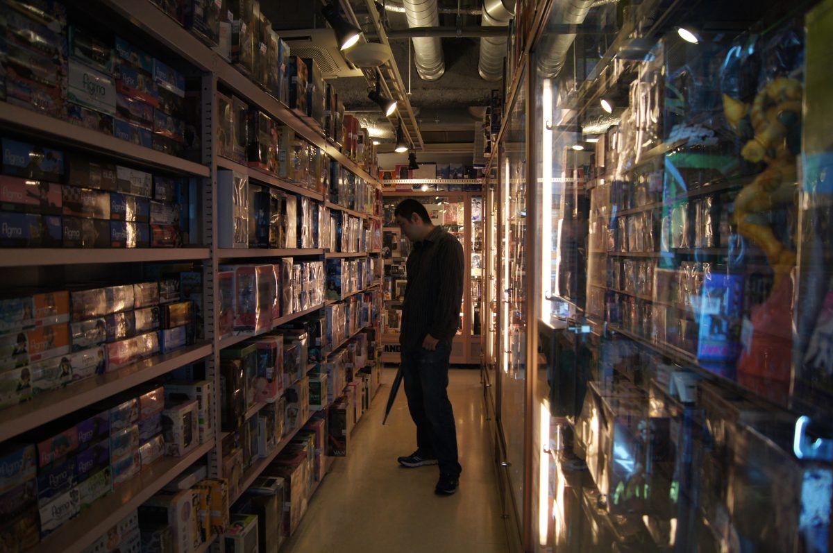 Akihabara 10 A narrow aisle lined with shelves of video games in an Akihabara shop