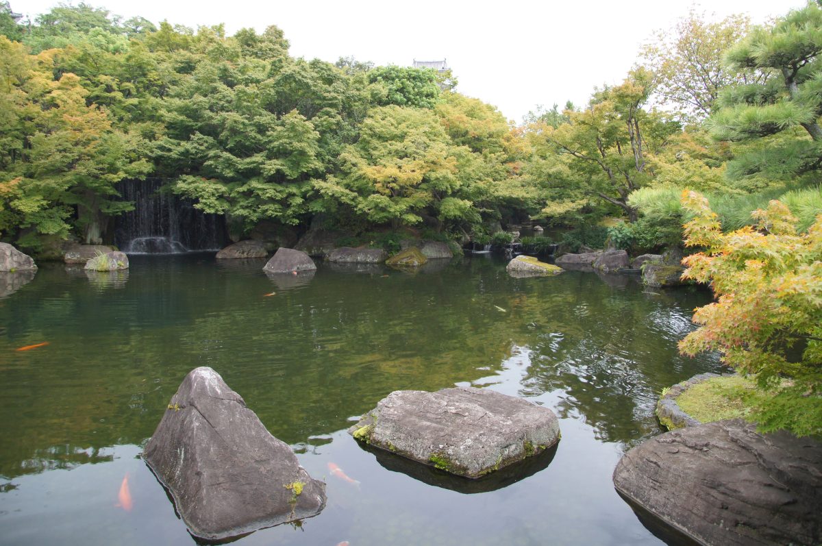 Pond with stepping stones and trees in Koko-en Garden, Himeji