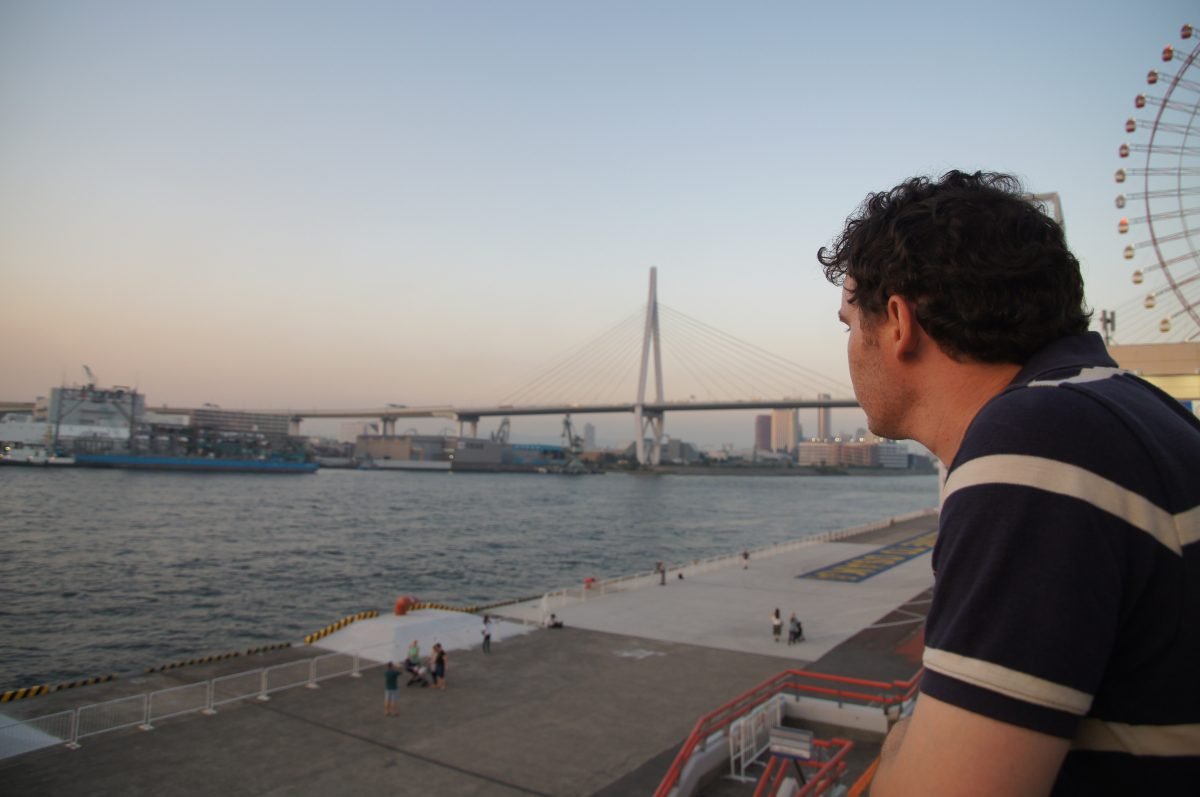 Gary looking across Osaka Bay near Osaka Aquarium Kaiyukan with the Tempozan Ferris Wheel behind