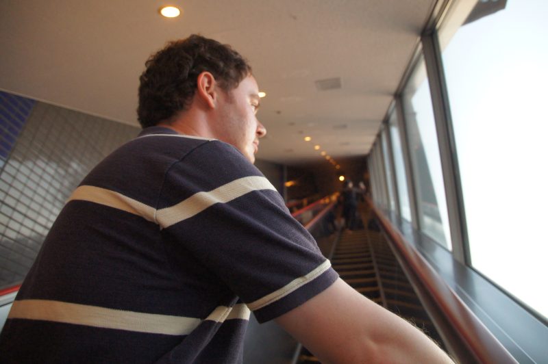 Gary riding an escalator inside Osaka Aquarium Kaiyukan