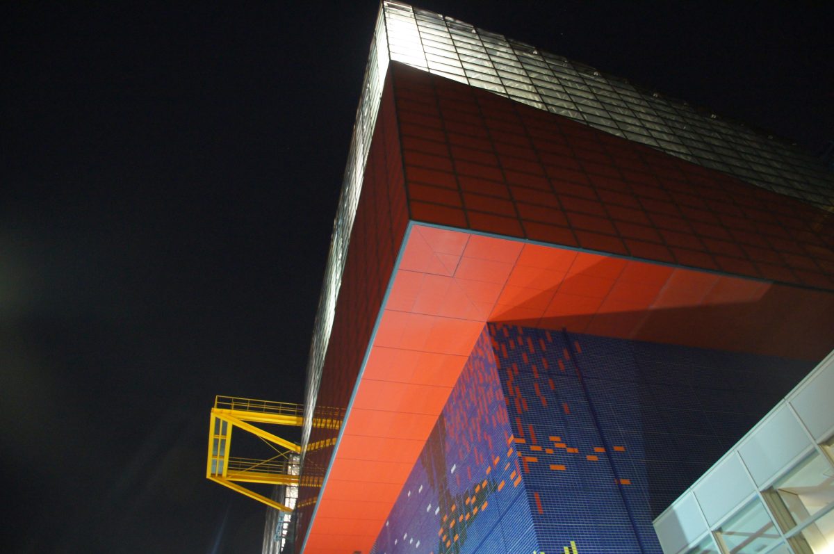 Orange and blue exterior of Osaka Aquarium Kaiyukan illuminated at night