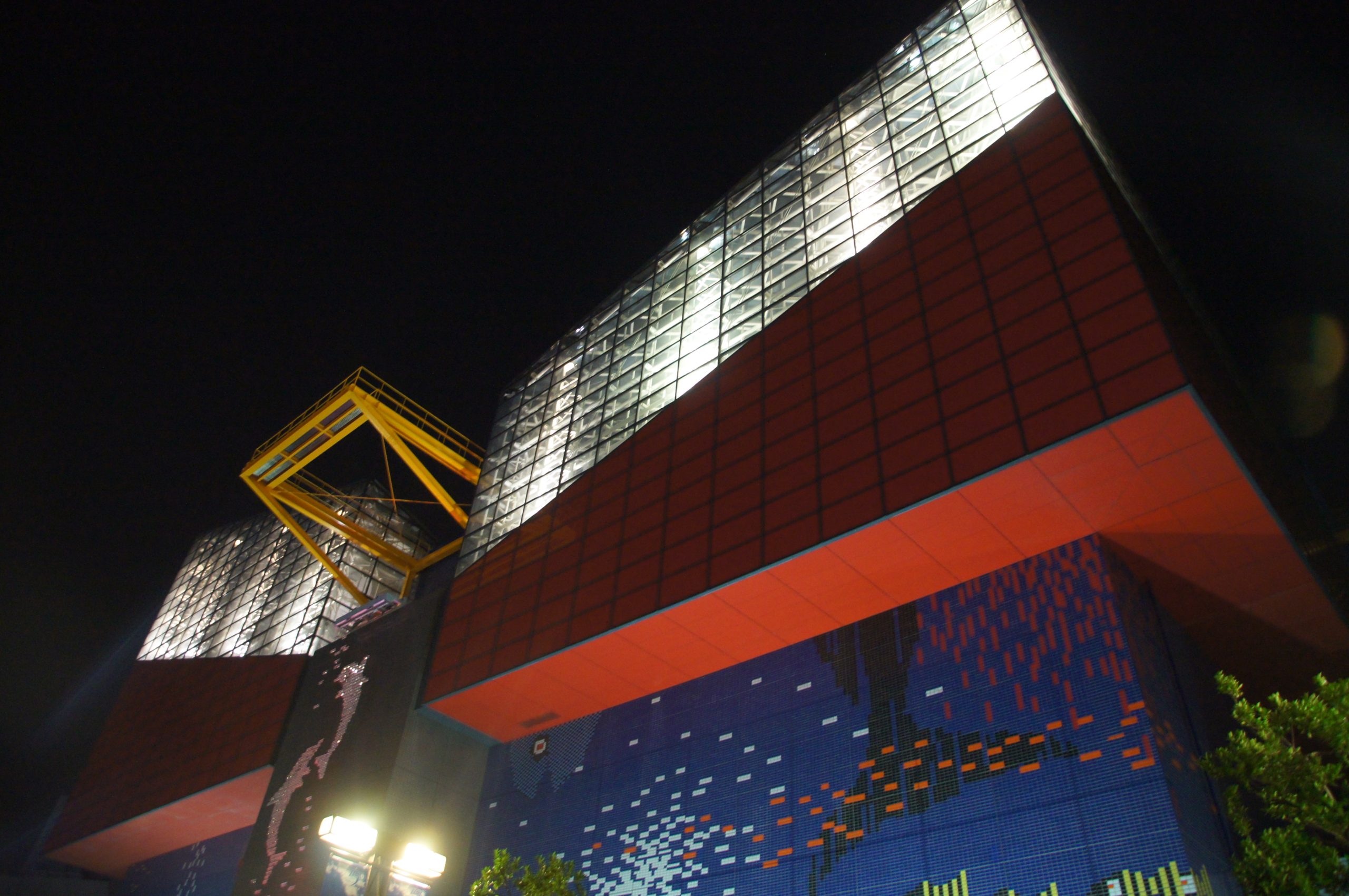 Osaka Aquarium Kaiyukan’s illuminated red and blue exterior at night