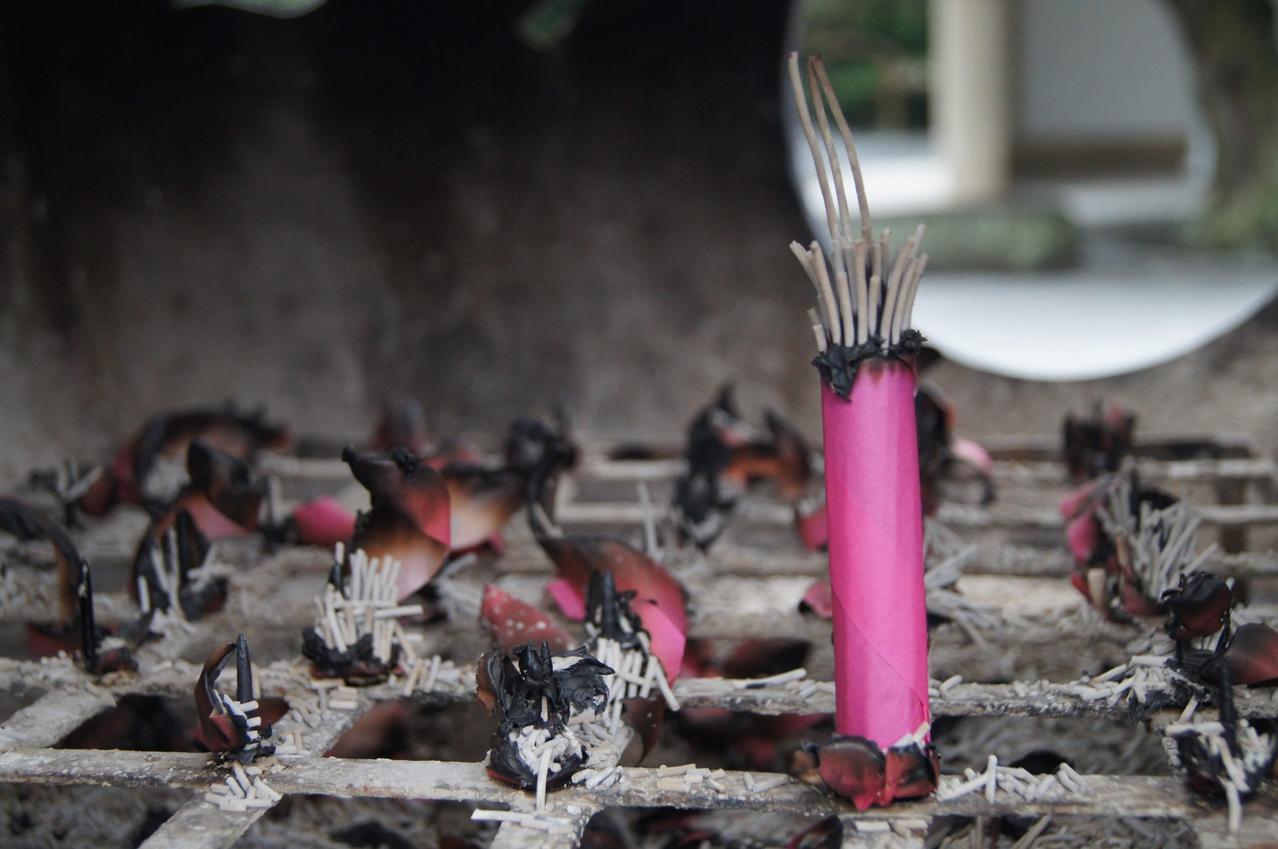 Pink incense sticks burn at Kotoku-in temple.