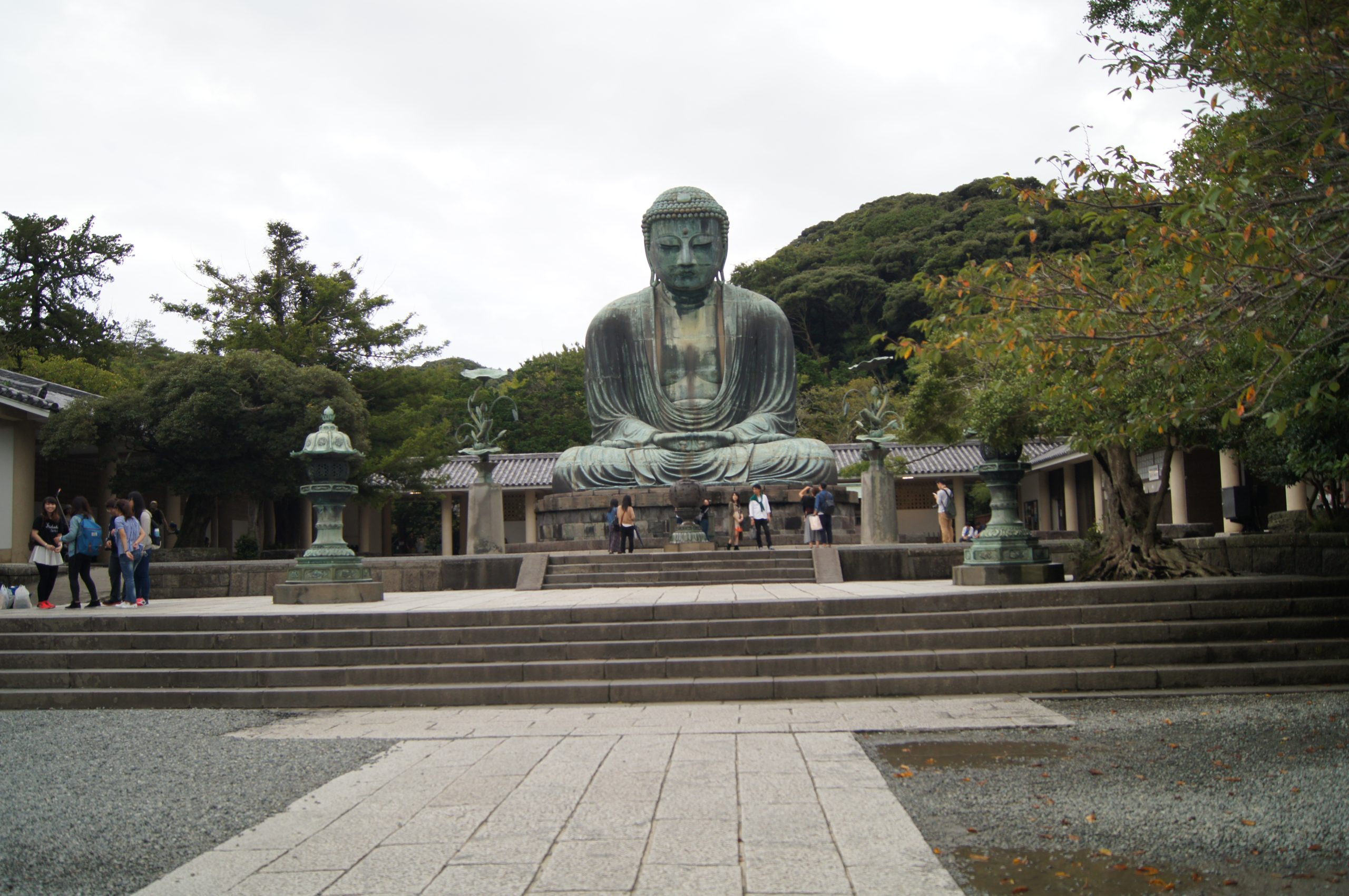 The seated bronze Great Buddha is viewed from the central stone path at Kotoku-in.