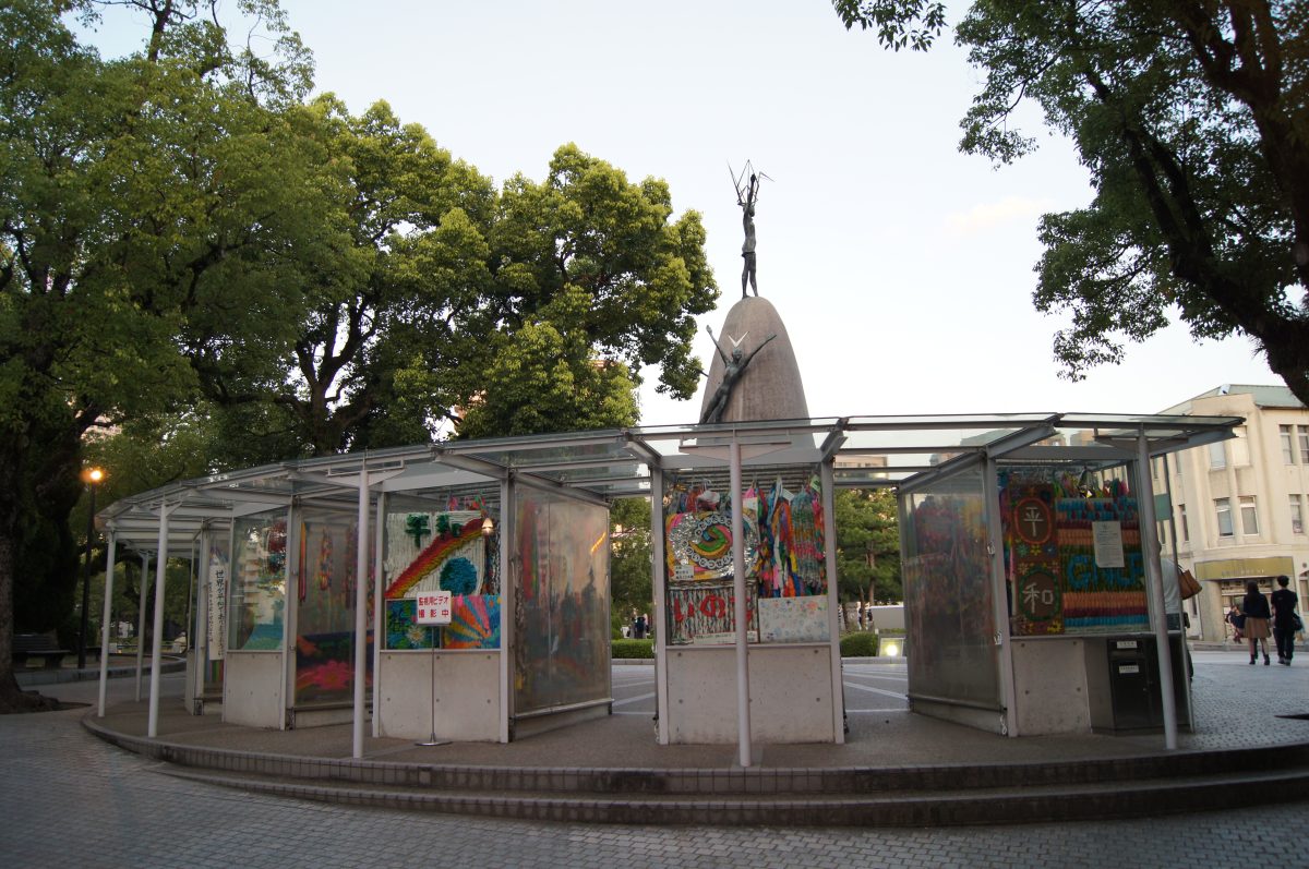 Children's Peace Monument surrounded by colourful paper-crane displays in Hiroshima Peace Memorial Park.