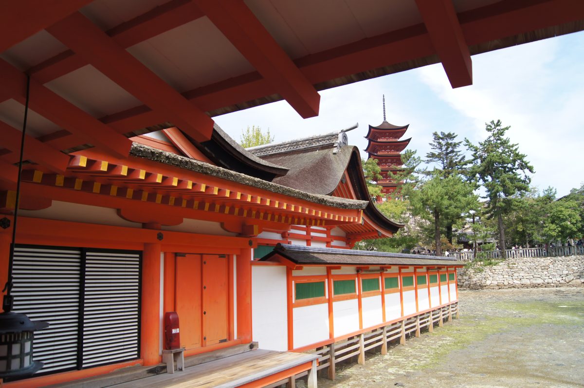 DSC06276 The vermilion exterior of Itsukushima Shrine, with the Five-Storied Pagoda rising behind the roofline on Miyajima.