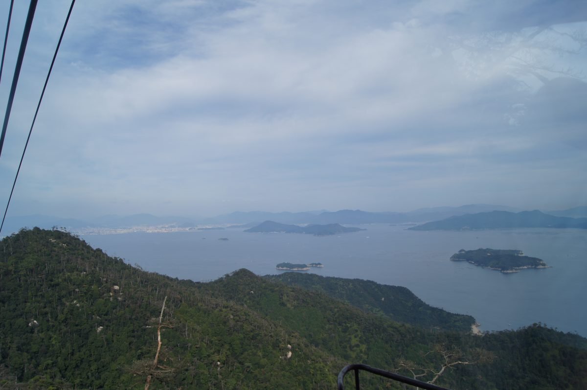 DSC06323 A ropeway cable crosses a wide view of forested hills and islands in the Seto Inland Sea on Miyajima.