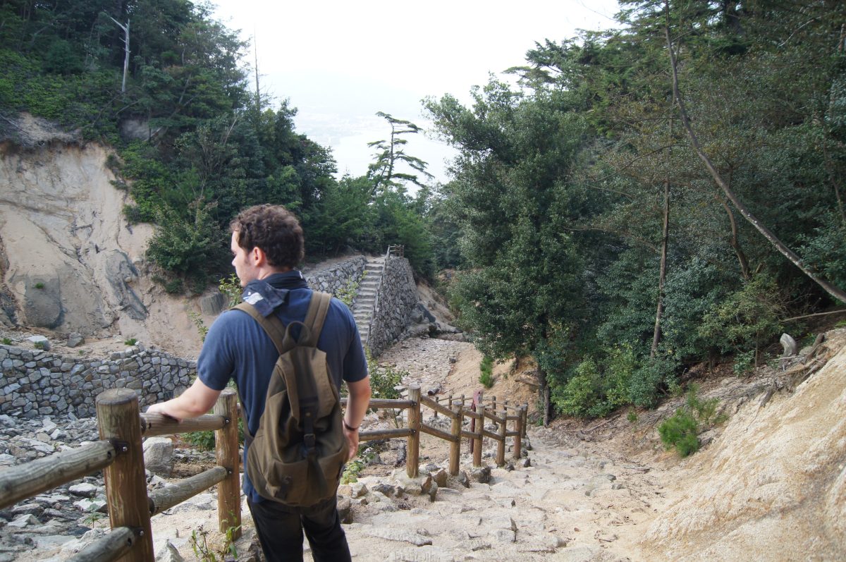 DSC06356 A visitor walks down a rocky forest trail on Mount Misen, Miyajima.