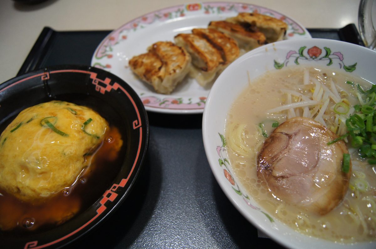 A bowl of ramen, pan-fried gyoza and a small egg dish served at a restaurant in Nara.