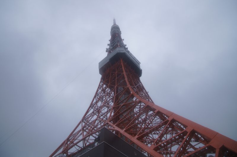 DSC07177 Tokyo Tower’s red steel framework rising into mist beneath a grey sky.