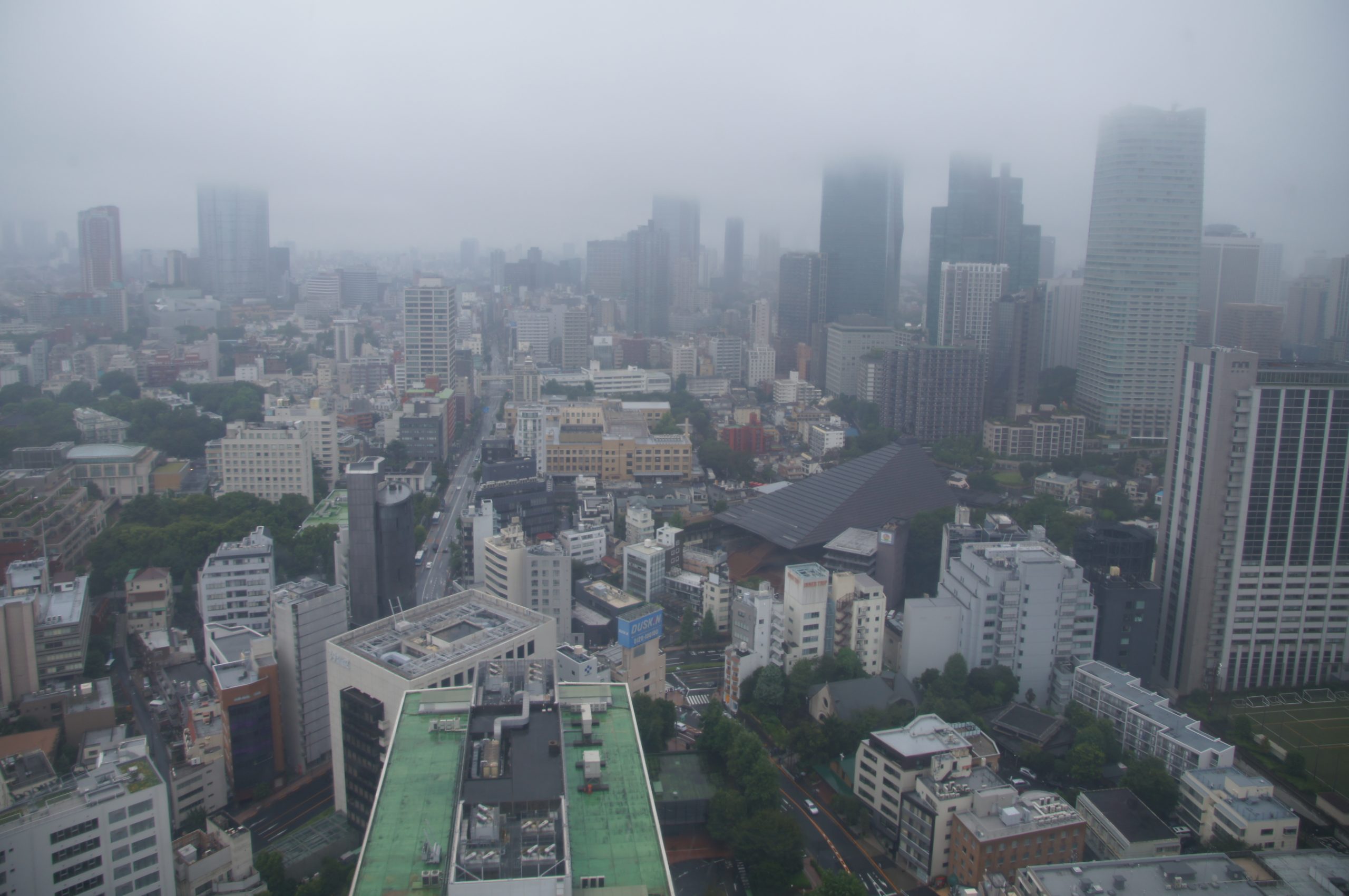 DSC07188 scaled Tokyo buildings beneath low cloud, seen from Tokyo Tower in 2017