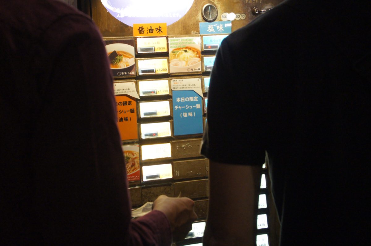 DSC07300 Visitor using a restaurant ticket machine inside Shin-Yokohama Ramen Museum
