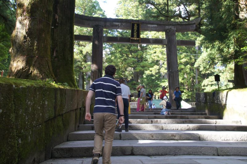 DSC07469 Gary climbing stone steps beneath a torii gate at Nikko Toshogu