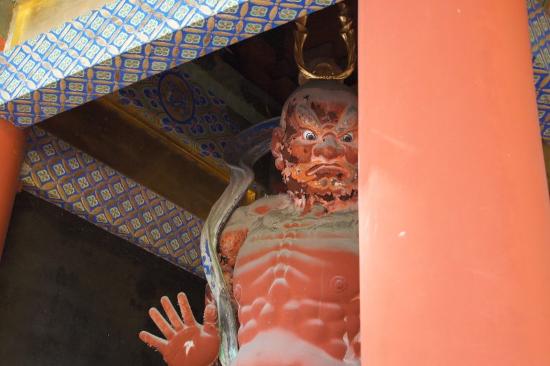 DSC07492 Painted guardian statue beneath the eaves at Nikko Toshogu Shrine