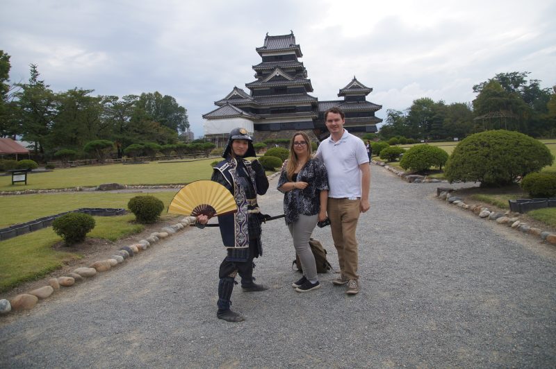 DSC09243 Kat and Gary posing with a costumed samurai performer in front of Matsumoto Castle
