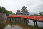 Matsumoto Castle behind the vermilion bridge crossing its moat