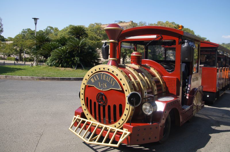 DSC09565 2 Red road train carrying visitors through Osaka Castle Park