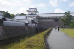 Kanazawa Castle buildings and stone walls beside the moat under a blue sky