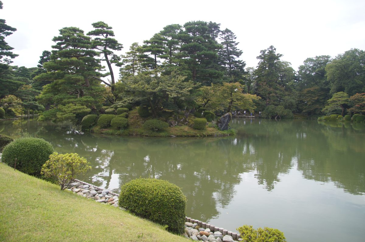 Landscaped pond, pine trees and clipped shrubs in Kenroku-en Garden