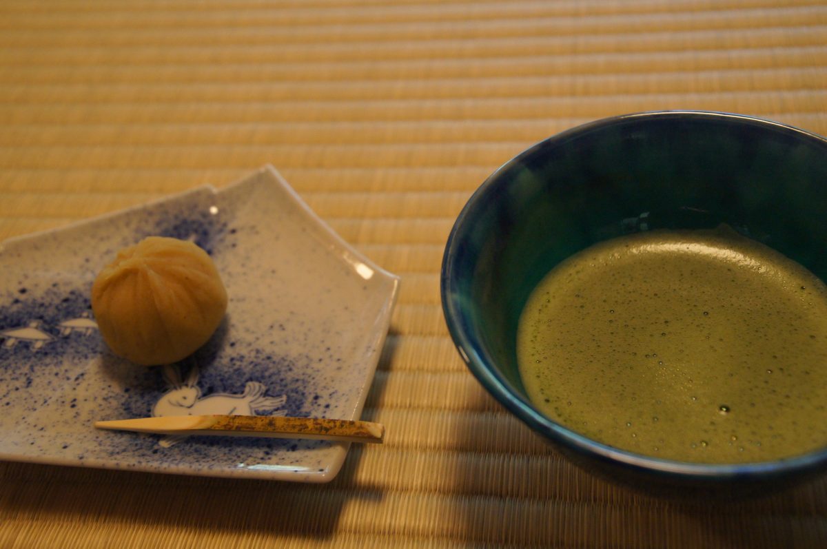 Bowl of matcha beside a seasonal Japanese sweet at Shigure-tei in Kenroku-en